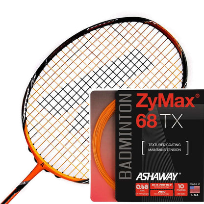 Close-up of a badminton racket showcasing an orange and black pattern on the strings, featuring ZyWeave string technology. Next to it is a 10-meter packet of Ashaway Zymax 68 TX badminton strings in orange, distinguished by its red and black packaging that highlights "textured coating maintains tension.