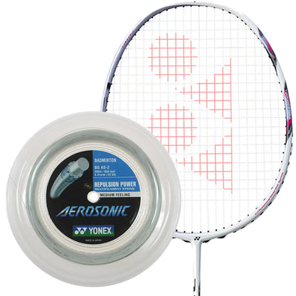 A Yonex badminton racket features a white string pattern adorned with a logo, complemented by the Yonex Aerosonic Badminton String White - 0.61mm 200m Reel. This transparent reel, revealing its coiled strings inside, is marked for its exceptional repulsion power and medium feeling.