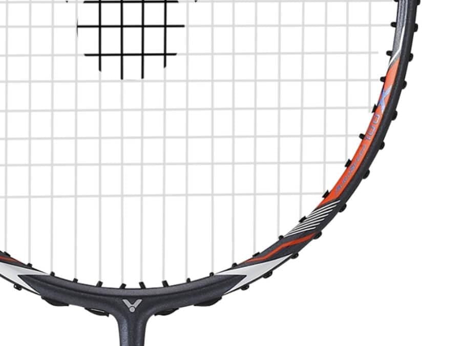 Close-up of the top half of a badminton racket with a grey and orange frame featuring white strings, highlighting Sonic-Rebound Technology. The image focuses on the detailed string pattern and frame design, reminiscent of the precision found in the Victor Auraspeed 100X H Badminton Racket.