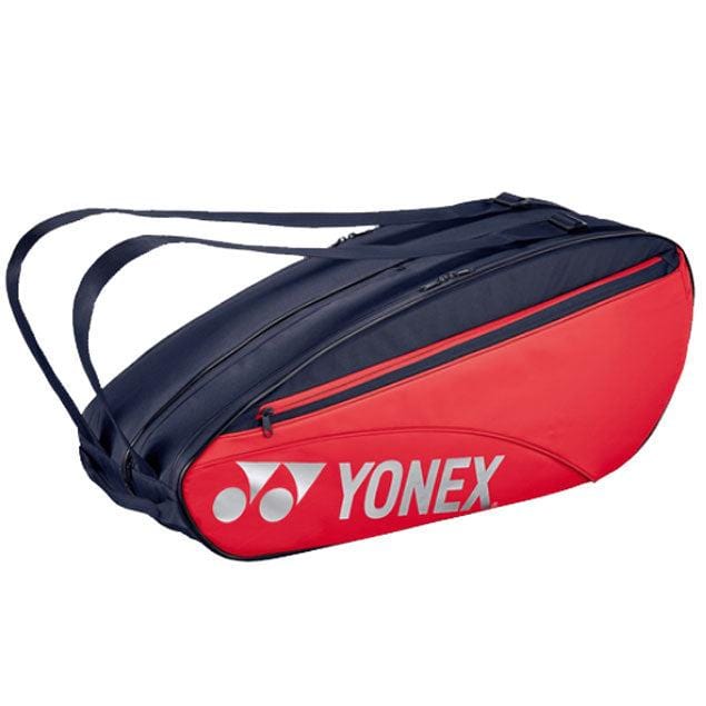 The Yonex 42326EX 6 Piece Racket Bag in Scarlet, designed by Yonex, boasts adjustable shoulder straps for comfort and includes a dedicated wet compartment to keep your gear organized.