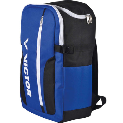 Introducing the Victor Backpack BR6011 Blue Badminton Bag: This lightweight backpack comes in blue and black with white zippers and a convenient side pocket. Adorned with the brand name "Victor" printed vertically in white on the front, it offers a spacious main compartment, multiple storage sections, and adjustable shoulder straps for enhanced comfort.