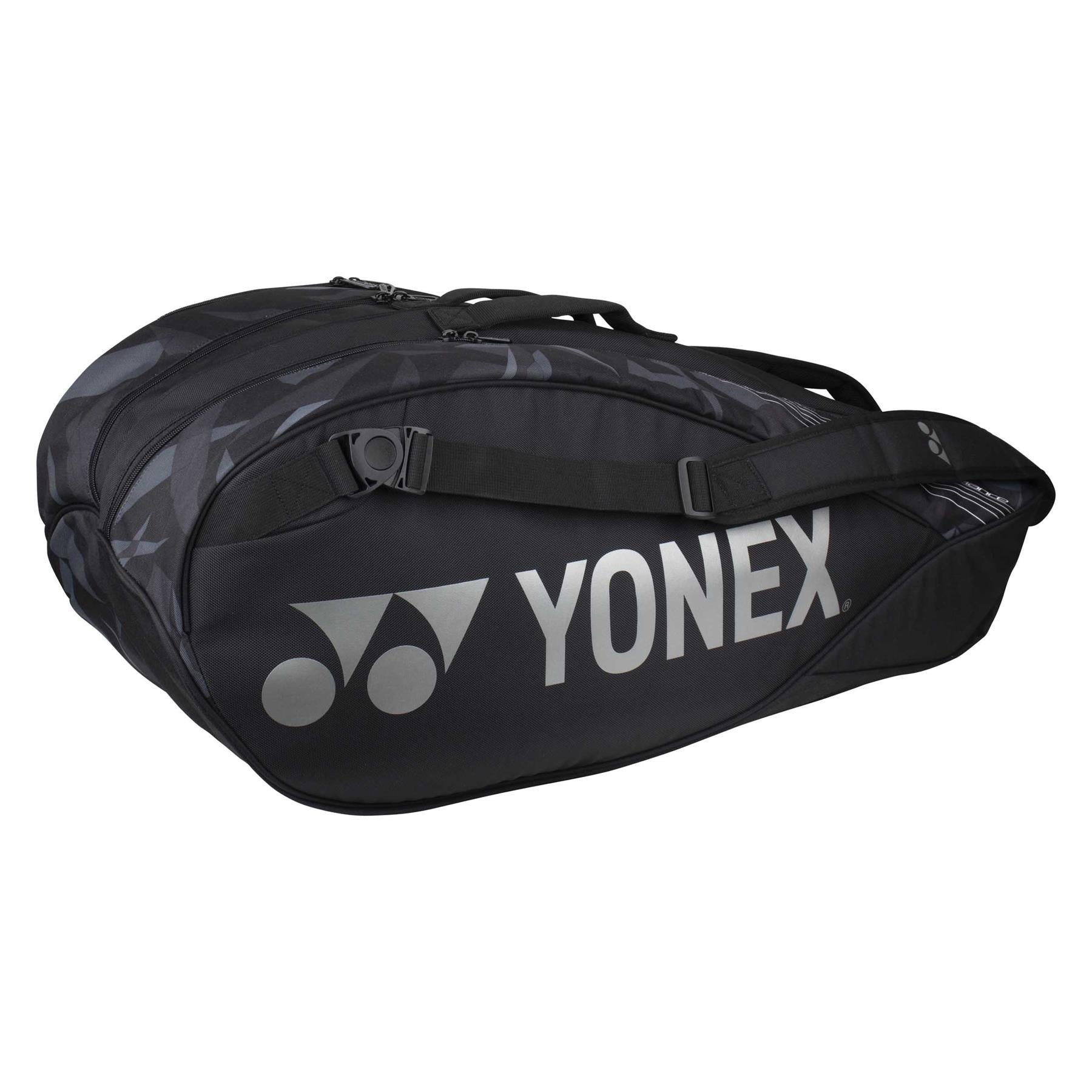 Yonex's 6 Piece Pro Badminton Racket Bag 92226 in black showcases a sleek, streamlined design with a prominent logo on the side. This multi-functional bag includes an integrated shoe pocket, multiple compartments, handles, and an adjustable shoulder strap for ultimate convenience.