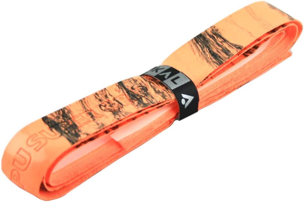 The Karakal PU Badminton Super Grip Marble Effect Single in orange, rolled up and secured with a black strap, features a textured marble pattern with earthy colors, showcasing its reliable grip for enhanced traction.