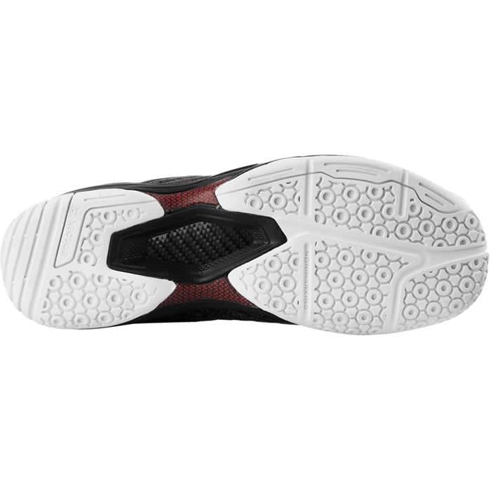 The image displays the underside of a VICTOR A922 Black Badminton Shoe, presenting a black and white sole. Featuring EnergyMax 3.0 technology, the sole has a unique pattern of hexagons and grooves for enhanced traction. The central section showcases an advanced red and black textured design, indicating its integration of DigitKnit technology by Victor.