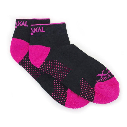 A pair of Karakal X2+ Women's Technical Trainer Badminton Socks in black with bright pink accents on the toes, heels, and cuffs. Designed specifically for badminton, these socks feature pink text and dotted patterns for a stylish look, along with anti-slip bottoms that provide stability during intense play. Available in sizes UK3-UK7.