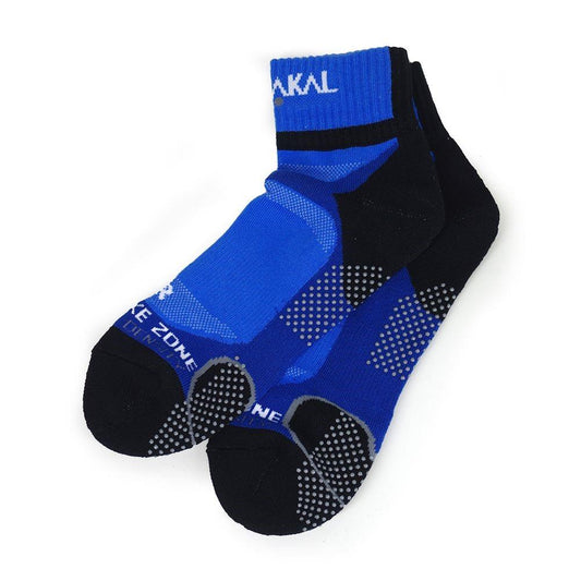 The Karakal X4 Men's Technical Ankle Badminton Socks in blue and black (UK7-UK13) are made from Cool Tec material and feature white text. These socks have small sole dots for grip, "RAKAL" on the cuff, and utilize shock-absorbing technology for comfort with a soft, stretchy fabric.