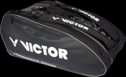 The Victor Multithermo 9031 Badminton Bag in black features "Professionals Edition" printed on the side in white text. It includes two visible zippers, straps on top, and padded shoulder straps for comfort, making it perfect for carrying your sports equipment.