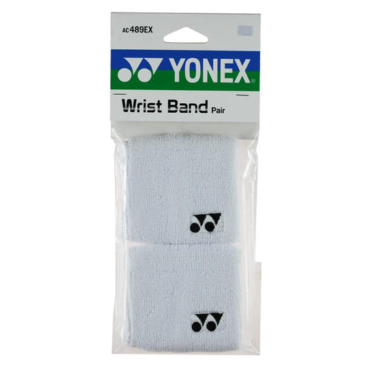 A package of Yonex AC489EX Badminton Sweat Wristbands includes a pair of white, soft, sweat-absorbing wristbands featuring the Yonex logo in black. The packaging is clear plastic and has a label at the top displaying the Yonex logo along with product details.