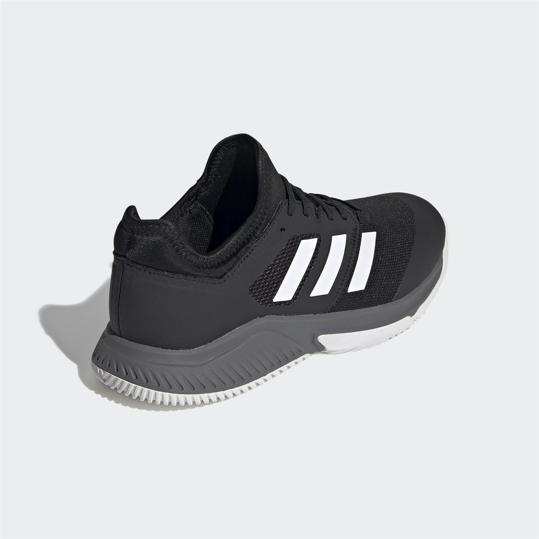 A back-angle view of the Adidas Court Team Bounce Men's Badminton Shoe in black reveals a textured gray sole, with a black upper made from Primegreen recycled materials. Featuring padded ankle support, this shoe is designed for badminton players who prioritize both style and comfort.