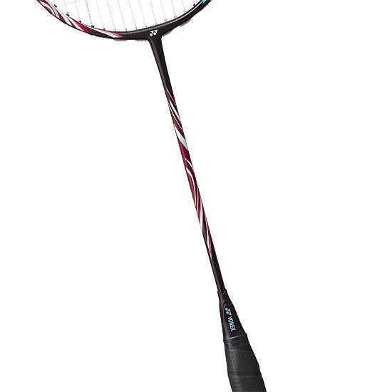 The Yonex Astrox 100 Tour 3U Kurenai Badminton Racket - Red showcases a black handle and an elegant red, white, and black pattern on the shaft. It's made with NAMD graphite material to boost performance and offers a head-heavy balance for powerful smashes.