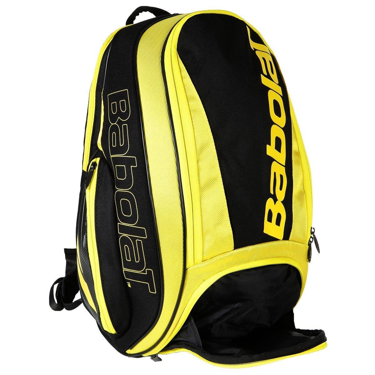 The Babolat Pure Aero Backpack - Yellow/Black is a stylish racket bag from Babolat, showcasing multiple compartments with ventilated sections, a main zipper, and a slightly open bottom pocket. The bag prominently features the Babolat logo on the front and side.