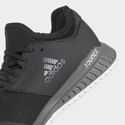 Close-up of the black Adidas Court Team Bounce Men's Badminton Shoe showcasing the iconic logo in silver on the side. Designed with sleek precision, it features "BOUNCE" etched on the black sole accented in white. Crafted using Primegreen recycled materials, this shoe seamlessly combines style with sustainability.