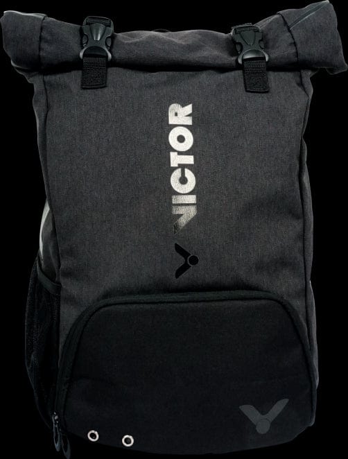 The Victor 9101 Rucksack Badminton Bag - Black by Victor showcases a roll-top design with "VICTOR" and the brand logo in white on the front. It includes a zippered front pocket with grommet details, generous compartments for shoes and rackets, as well as two adjustable clasps at the top for secure closure.