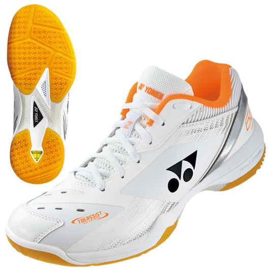 A pair of Yonex Power Cushion 65Z3 Wide Men's Badminton Shoes in white and orange. The main shoe features a silver and orange design with Yonex Power Cushion laces, complemented by a Radial Blade Sole with yellow tread—ideal for both sports and casual wear.