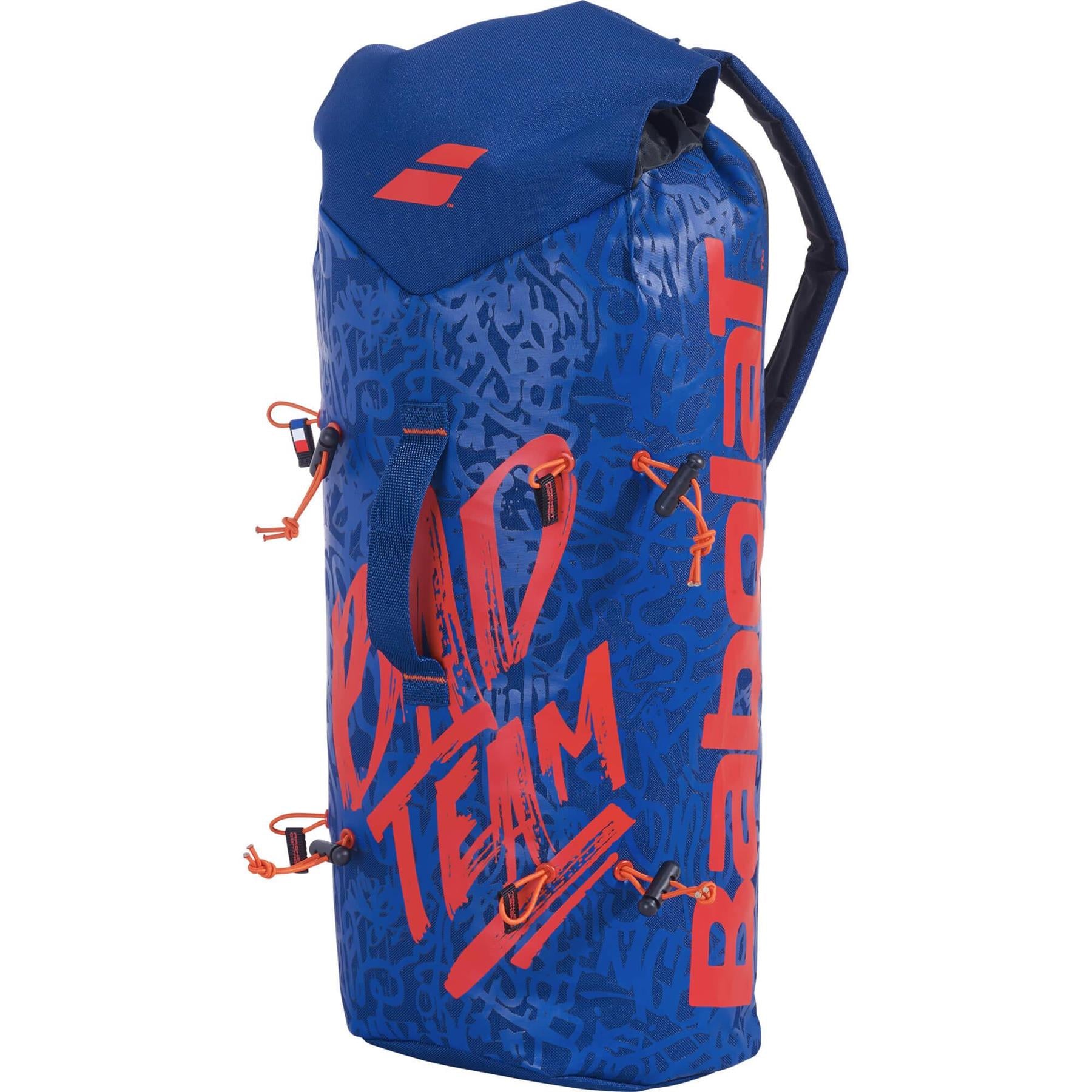 A blue and red Babolat Badminton Sling Bag, embellished with abstract patterns. This fashionable racket holder comes with black straps and orange accents, prominently featuring the bold "Babolat" and "Team" logos.