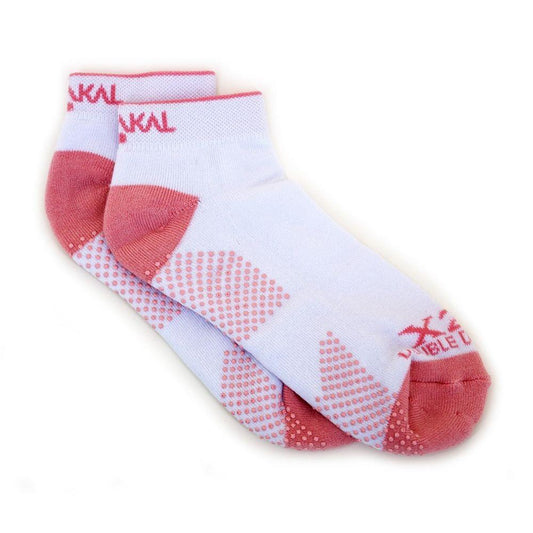 A pair of Karakal X2+ Women's Technical Trainer Badminton Socks in white and pink, featuring textured, anti-slip patterns on the soles and red branding near the cuffs. Suitable for sizes UK3 to UK7.