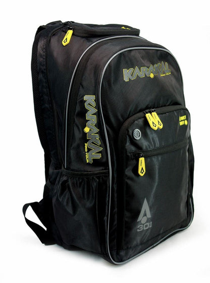 The Karakal Pro Tour 30 2.0 Badminton Backpack in black features a sleek design with striking yellow zippers and branding. It includes multiple compartments, side pockets, and adjustable shoulder straps highlighted with the "Karakal" logo and "A 303" markings in bold yellow and gray.