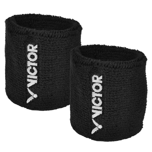 The Victor Badminton Wristband - Black - 2 Blister features the brand name "Victor" embroidered in white on a textured, stretchy material, combining style and comfort.