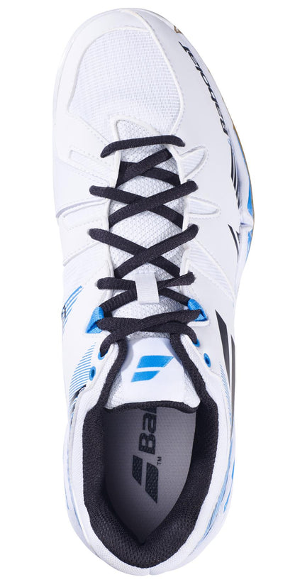 Top view of a Babolat Shadow Spirit Men's Badminton Shoe in white with black laces, featuring blue accents and the Babolat logo on the tongue and side. This shoe offers exceptional comfort with an Ortholite Die Cut insole, ensuring you stay light on your feet while exuding style.