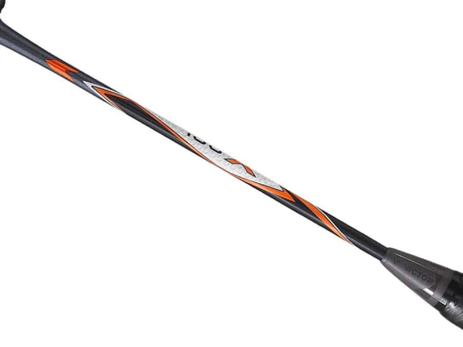 Close-up view of a grey and orange badminton racket shaft featuring a unique geometric pattern. The brand name "VICTOR" is clearly visible near the base, highlighting the Victor Auraspeed 100X H, which is equipped with Sonic-Rebound Technology for superior performance.