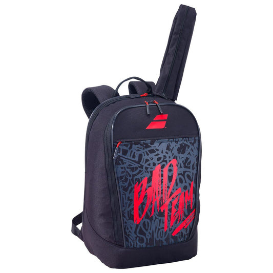 The Babolat Classic Club Badminton Backpack, Black/Red edition, showcases a modern urban design with red graffiti-style lettering saying "BAD TEAM." It includes a main zippered compartment, adjustable shoulder straps, a top handle, and a special compartment for your racket. This backpack is ideal for carrying your training gear.