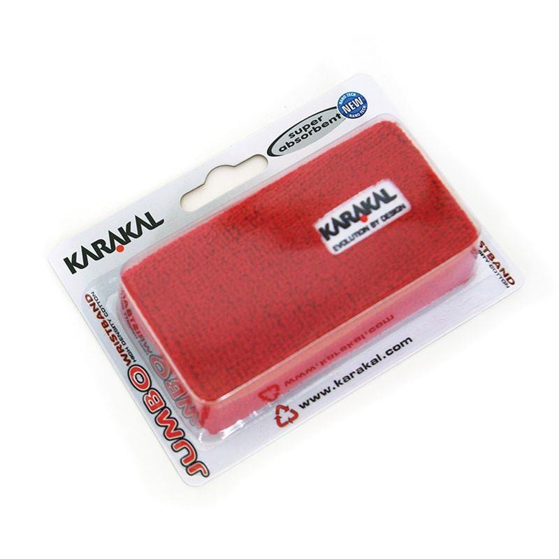 A red Karakal Jumbo Badminton Wrist Band, branded by Karakal and labeled "super absorbent," is displayed in its clear plastic packaging. The extra wide wristband, along with branding and product details, is easily visible through the packaging.