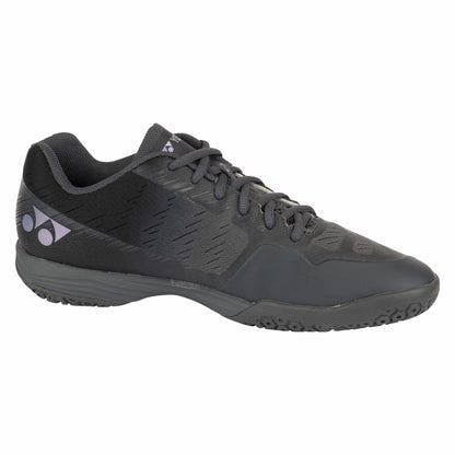 The Yonex Power Cushion Aerus Z Men's Badminton Shoes in Dark Grey are a sleek pair of athletic footwear featuring a textured sole and a stylish, subtle patterned design. They include a distinctive logo near the heel and are equipped with coordinating dark gray laces, making them perfect for badminton enthusiasts who prioritize both style and performance.