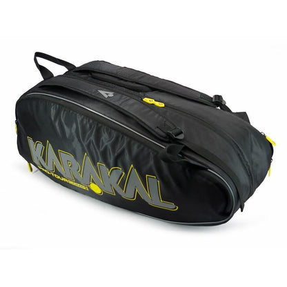 The Karakal Pro Tour 2.0 Comp Racket Bag showcases a sleek black design with yellow branding and zippers. Ideal for tournament players, this stylish bag includes carrying handles and adjustable double shoulder straps, making it effortless to transport sports equipment.