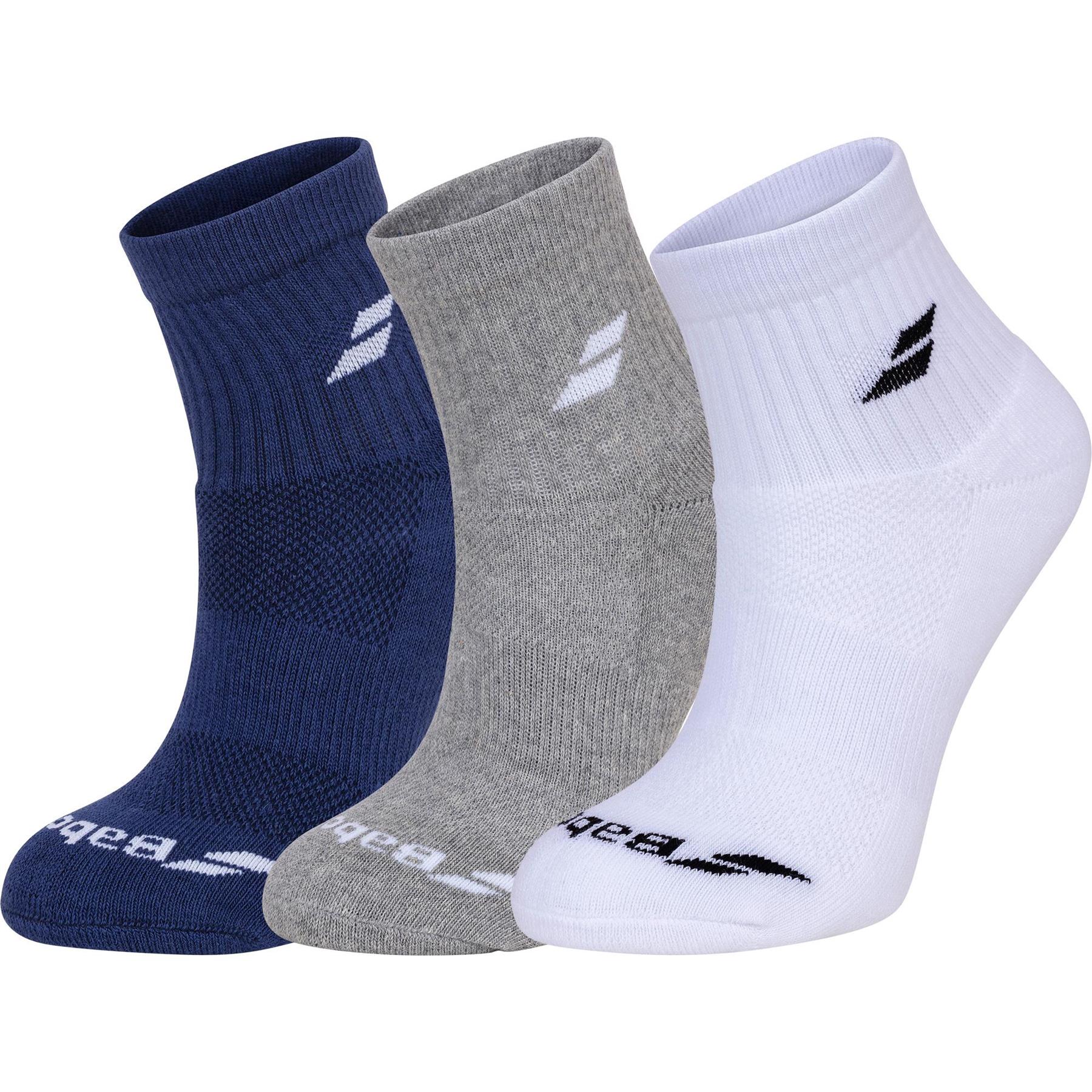 Three pairs of the Babolat Quarter Badminton Socks, available in navy blue, gray, and white, are displayed on a white background. Each sock is adorned with a stylized "B" logo near the top and features "Babolat" across the toe area. Designed for ultimate comfort and breathability, these socks stand proudly side-by-side.