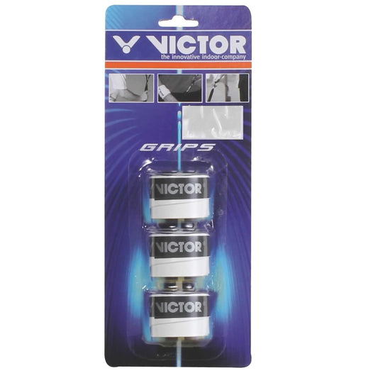 The packaging for the Victor Badminton Racket Overgrip 7197 showcases three white overgrips arranged in a vertical stack. Featuring a blue background, it emphasizes "GRIPS" and "Victor, the Innovative Indoor Company," ensuring an adhesive surface for superior grip.