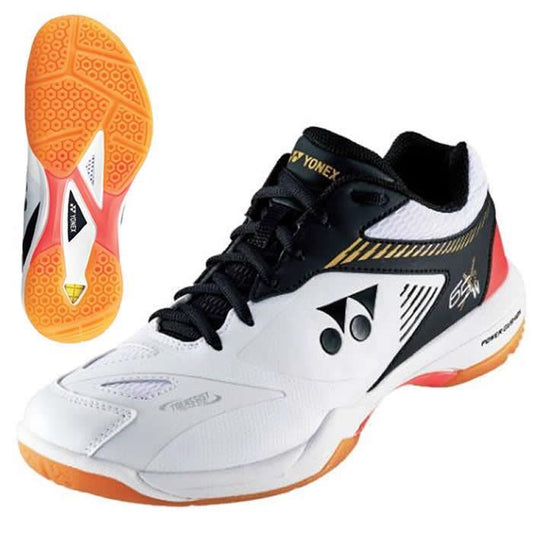 A pair of Yonex Power Cushion 65 X 2 Wide Badminton Shoes in white with orange detailing, featuring the Yonex logo on the side. The design incorporates gold accents and displays the brand name on the tongue. Additionally, a separate view showcases the shoe's textured sole pattern, emphasizing its wide fit optimized for high performance.