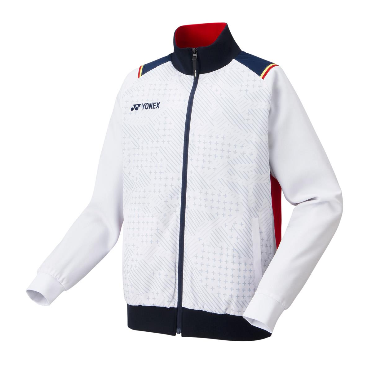 The Yonex 70090 Tracksuit Warm-Up Jacket in white showcases a geometric pattern on the front, complemented by a front zipper, dark cuffs, and a black collar. Red detailing accents the interior and sides of the jacket. Designed with Heat Capsule technology for added warmth, it also features ANTISTATIC properties. The Yonex logo is prominently displayed on the chest.