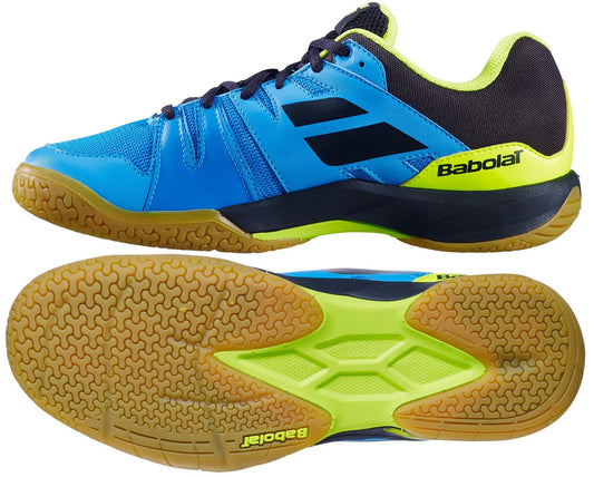 Introducing the Babolat Shadow Team Men's Badminton Shoes in Malibu Blue, featuring a dynamic design with neon green accents and textured gum soles crafted from Michelin rubber. Ideal for badminton enthusiasts, these shoes showcase the Babolat brand name and logo on both the side and sole, tailored specifically for athletic performance.