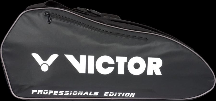 The Victor Multithermo 9031 Badminton Bag, branded "VICTOR" and part of the "PROFESSIONALS EDITION," comes in black and is designed for carrying sports equipment such as badminton or tennis gear. It features a sleek, tapered shape with a zippered closure that complements padded shoulder straps for enhanced comfort.