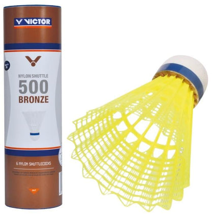 A set of six yellow nylon badminton shuttlecocks from Victor features a durable design with a blue base and a mesh skirt. The tube displays the brand "Victor" and reads "500 Nylon Badminton Shuttlecocks - Yellow Medium," representing the quality of these Victor Bronze 500 shuttles.