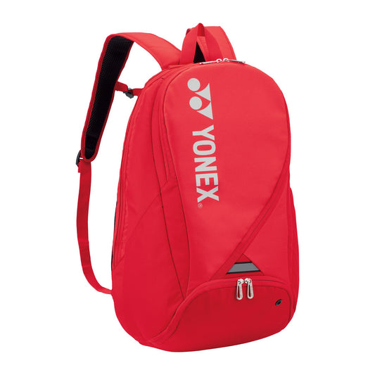 The Yonex Pro Badminton Backpack S 92212 - Tango Red, a stylish accessory with white text, is perfect for carrying your badminton essentials.