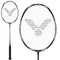 The Victor Jetspeed S10C Badminton Racket - Black Gold, made with Japanese carbon fibre, features a white string pattern and a stylized bird logo. Golden accents adorn the frame and handle, with a detailed close-up of its head displayed on the right side of the image.