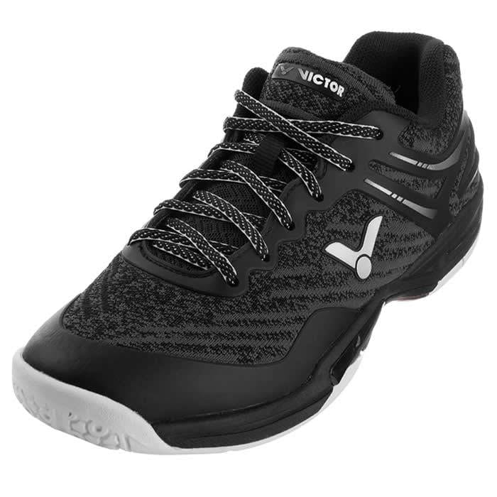 Introducing the VICTOR A922 Black Badminton Shoes by Victor, featuring a DigitKnit textured upper in black with a distinctive white logo on the side. These shoes boast black and white speckled laces, a cushioned tongue, and a non-marking sole. Engineered for peak performance, they incorporate EnergyMax 3.0 technology to deliver superior comfort.