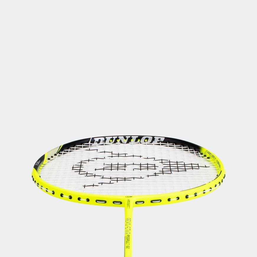 The Dunlop Revo Star Assault 82 badminton racket is designed in a striking bright yellow with the brand "Dunlop" prominently displayed on its frame. It is crafted from High Modulus Graphite and features black stringing over a white background.