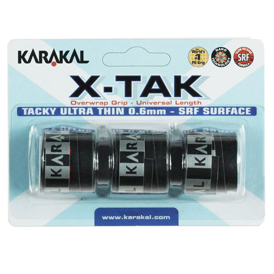 The packaging for the Karakal X-Tak Overwrap Badminton Grip - Black features a clear plastic container displaying three black grips adorned with silver branding. The text highlights "Tacky Ultra Thin 0.6mm - SRF Surface," emphasizing its non-slip qualities, along with branding and other product details.