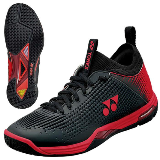 The Yonex Power Cushion Eclipsion Z2 men's badminton shoes in black and red feature a textured design and a lace-up closure. Equipped with the Yonex Power Cushion for improved comfort, these stability shoes showcase the brand's logo on the side, while their sole displays a distinctive tread pattern with additional branding for dependable performance.