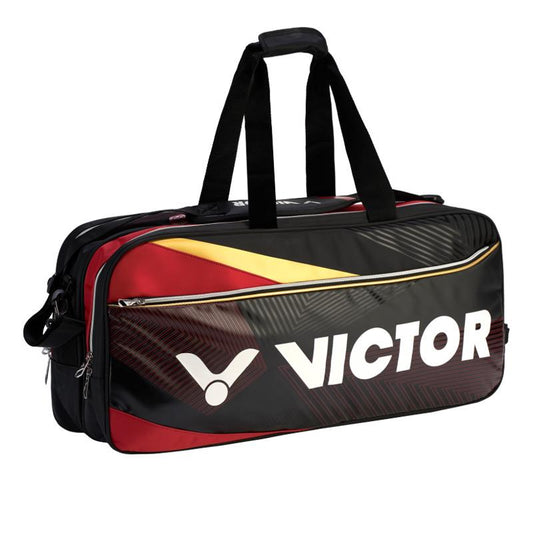 The Victor BR9609 CD Rectangular Badminton Bag in Black and Red is a premium square tournament bag featuring the word "VICTOR" prominently displayed on the side in white. It comes equipped with dual handles, a detachable shoulder strap, and a thermo compartment to ensure your gear stays in top condition.