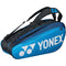 The Yonex 92026EX Pro 6 Piece Badminton Racket Bag in deep blue features the Yonex logo prominently. It can hold up to six rackets and includes a handy shoe compartment, complete with adjustable shoulder straps for comfortable carrying.