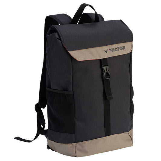 The Victor Rucksack BR3020 CH Badminton Bag in black and beige boasts a flap closure with a buckle, dedicated shoe compartments, and adjustable shoulder straps. The sleek design features the "Victor" logo on the flap, providing a simple yet functional option with flexible volume for all your essentials.