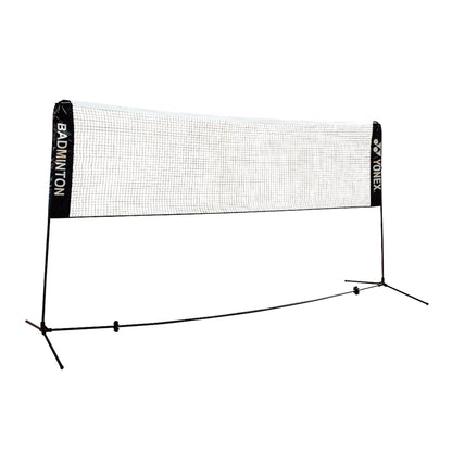 The Yonex AC334EX Portable Badminton Net is a recreational-level net designed with a white mesh and black supports, featuring "BADMINTON" and "YONEX" printed on the side panels. It includes a compact carry case for convenient transport, all beautifully displayed against a clean white background.