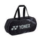 A stylish Yonex 92231W Pro Tournament Badminton Bag in black, boasting a geometric design and durable handles with the Yonex logo prominently displayed on the side. This sleek racket bag is ideal for tournament players.