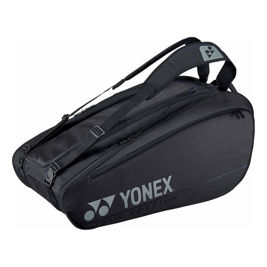 The Yonex 92029EX Pro 9 Piece Badminton Racket Bag in black showcases the brand logo in white letters and includes several zippered compartments. As a Pro Badminton Racket bag, it features two adjustable shoulder straps and is part of the "Tour Edition," made with isothermal material for superior protection of your equipment.