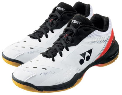 The Yonex Power Cushion 65Z3 Badminton Shoes in White and Red feature black laces and soles, red accents at the heel, and a logo on the sides. These shoes are designed with Toe Assist Shape to provide exceptional support and agility on the court.