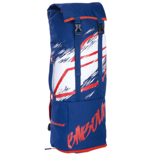 The Babolat Backrack 2 Bag Blue/White/Red by Babolat showcases red accents and creative white brushstroke designs against its blue backdrop. Constructed from recycled PET, it includes a rolled top with buckle closures and prominently displays "Babolat" in red on the side.