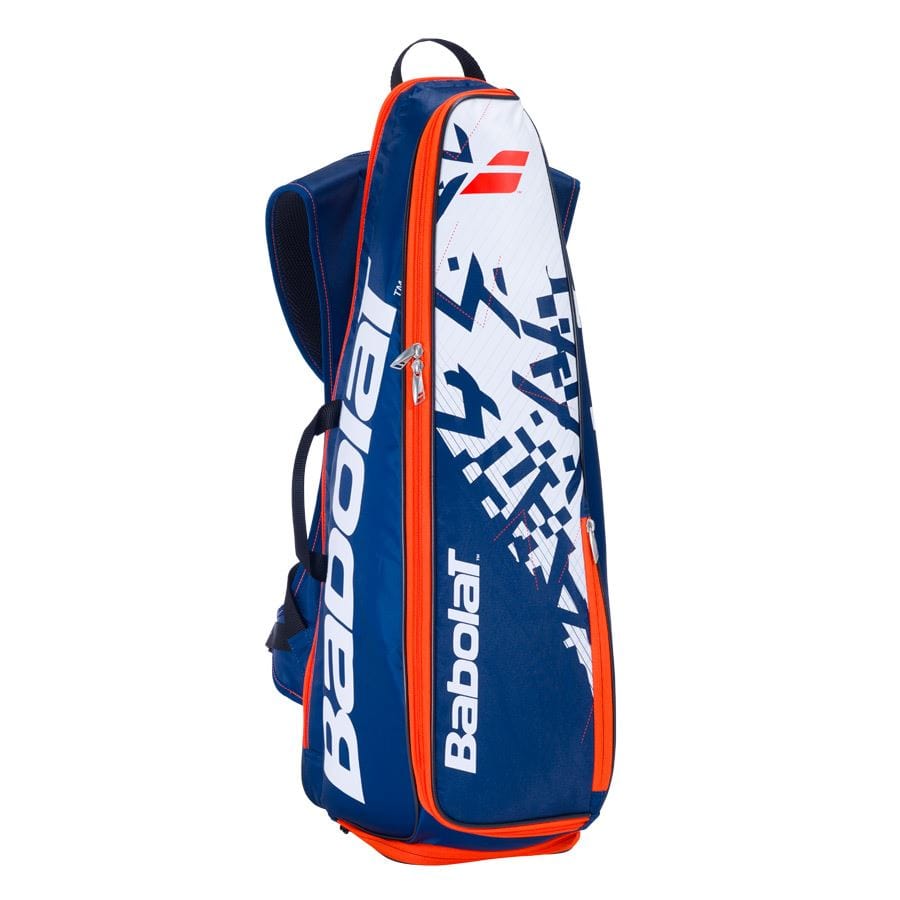 A blue and white Babolat Backracq Badminton Bag, ideal for transporting your gear. It displays a graphic design on the front along with the iconic Babolat logo. This bag includes a zippered compartment, adjustable shoulder straps, and even a shoe compartment to keep everything organized.